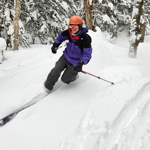 Telemark skier slices through powder snow